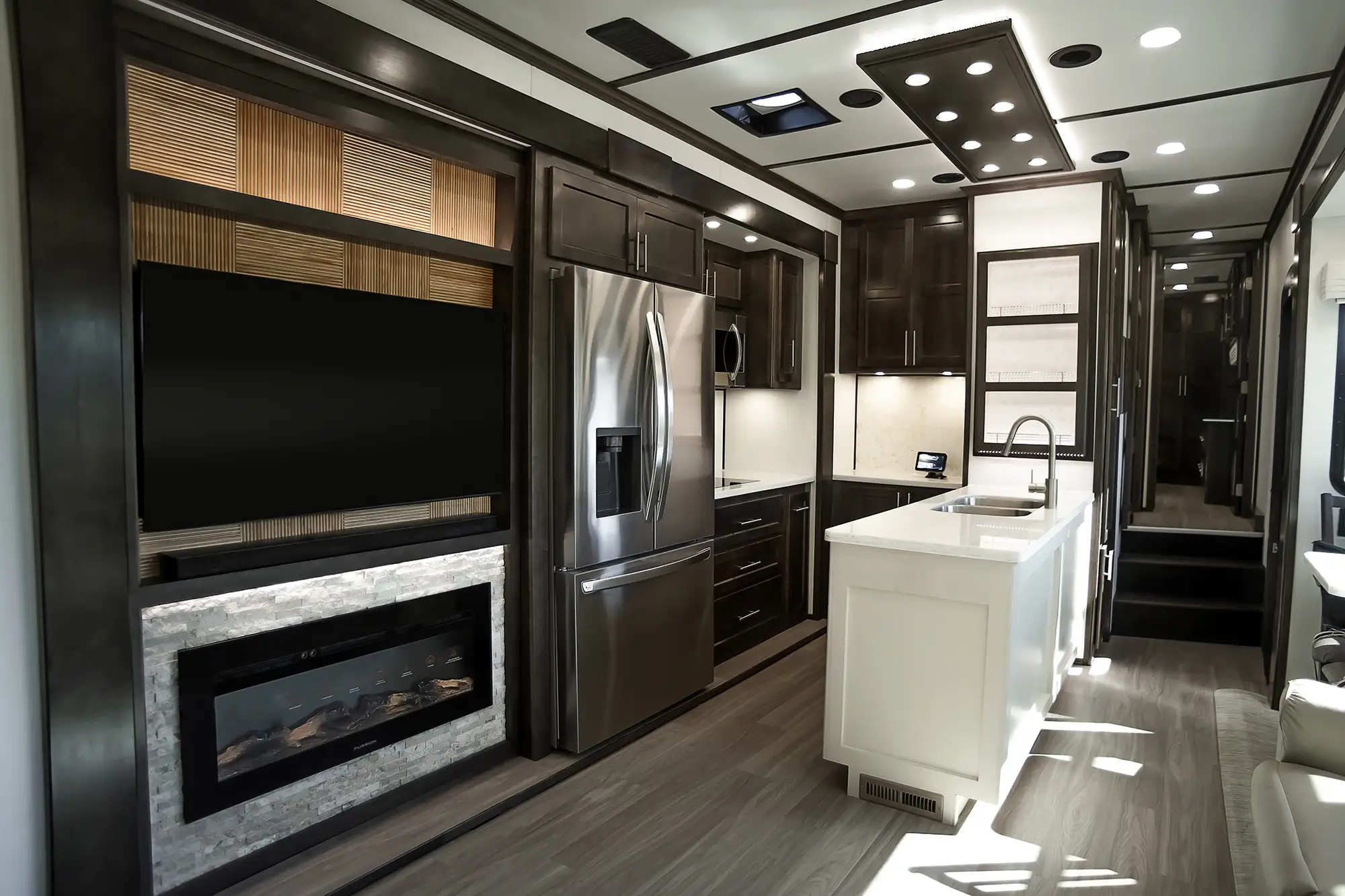 luxe-fifth-wheel-brazilian-walnut-cabinetry Brazilian Walnut cabinetry in the kitchen of a luxury fifth wheel made by Luxe Fifth Wheel.
