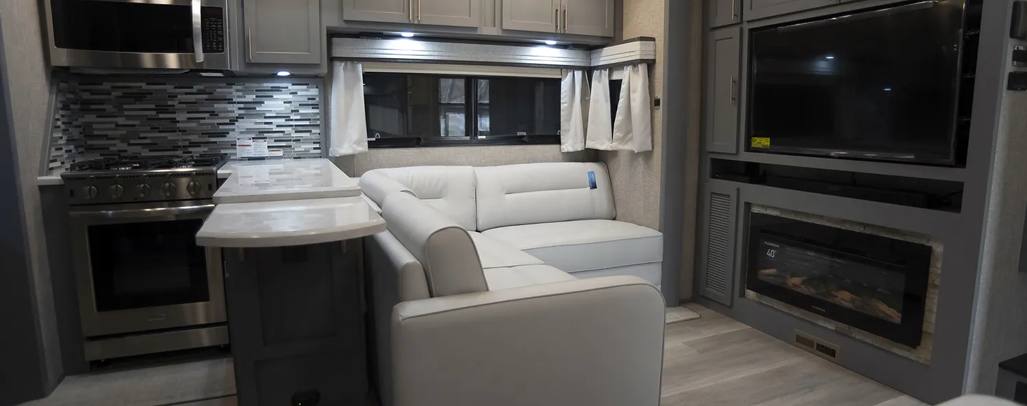 A spacious living Room in a luxury toy hauler fifth wheel, built by Luxe Fifth Wheel out of Elkhart Indiana.